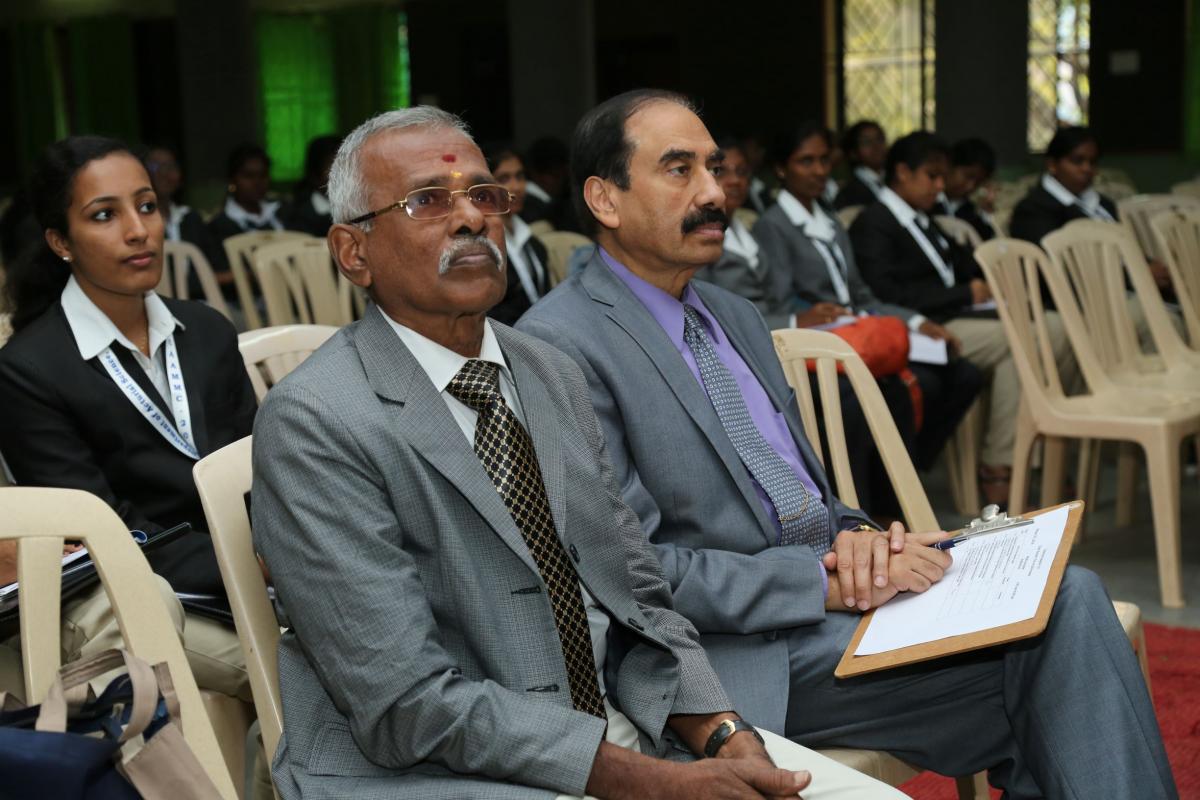 Dinesh sitting at conference