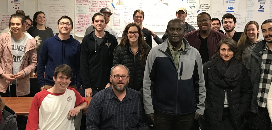 Valence Lutaisire, founder of Ugandan NGO  "Youth Focus Africa Foundation,” speaks with Social Entrepreneurship students during international Education Week.