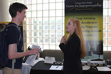 Students conversing at the Expo