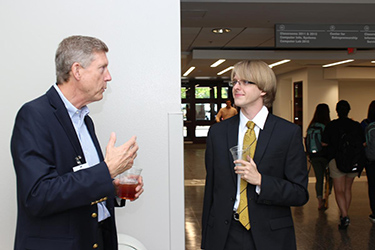 Student and faculty member converse