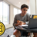 Zach Covington, a first-year exercise science major at Appalachian, looks at his laptop while taking notes. Photo by Chase Reynolds