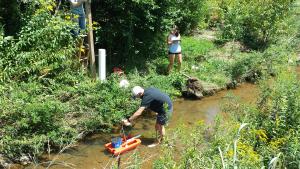 Eric Cheek ’18, Quantitative Geoscience major and Carly Maas, senior, Quantitative Geoscience major, measuring stream discharge in Boone Creek. Photo by Dr. William Anderson.