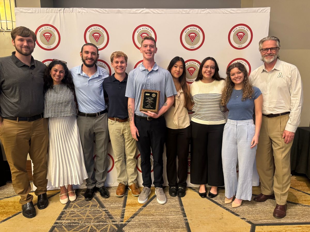 Aidan Sands (center) with fellow members of App State&rsquo;s chapter of Beta Alpha Psi and Faculty Advisor Brian Hasson (right).