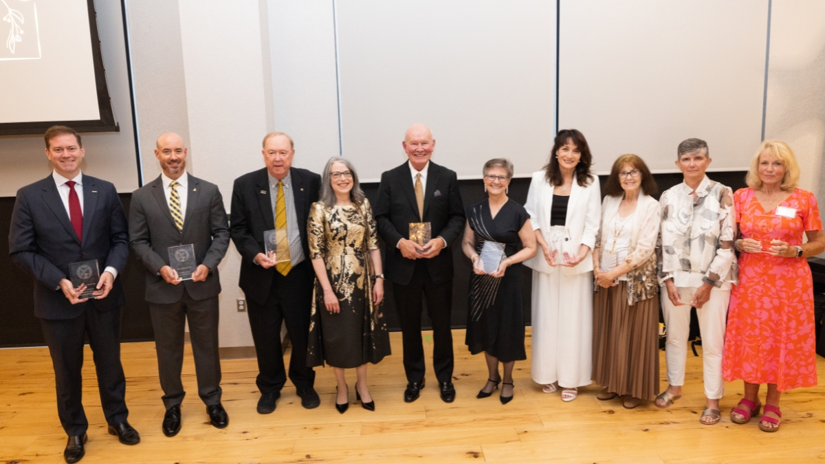  Nine alumni from the university&rsquo;s academic colleges, as well as the Honors College, Williams School of Graduate Studies and University Libraries, stand, holding awards, with App State Chancellor Norris.