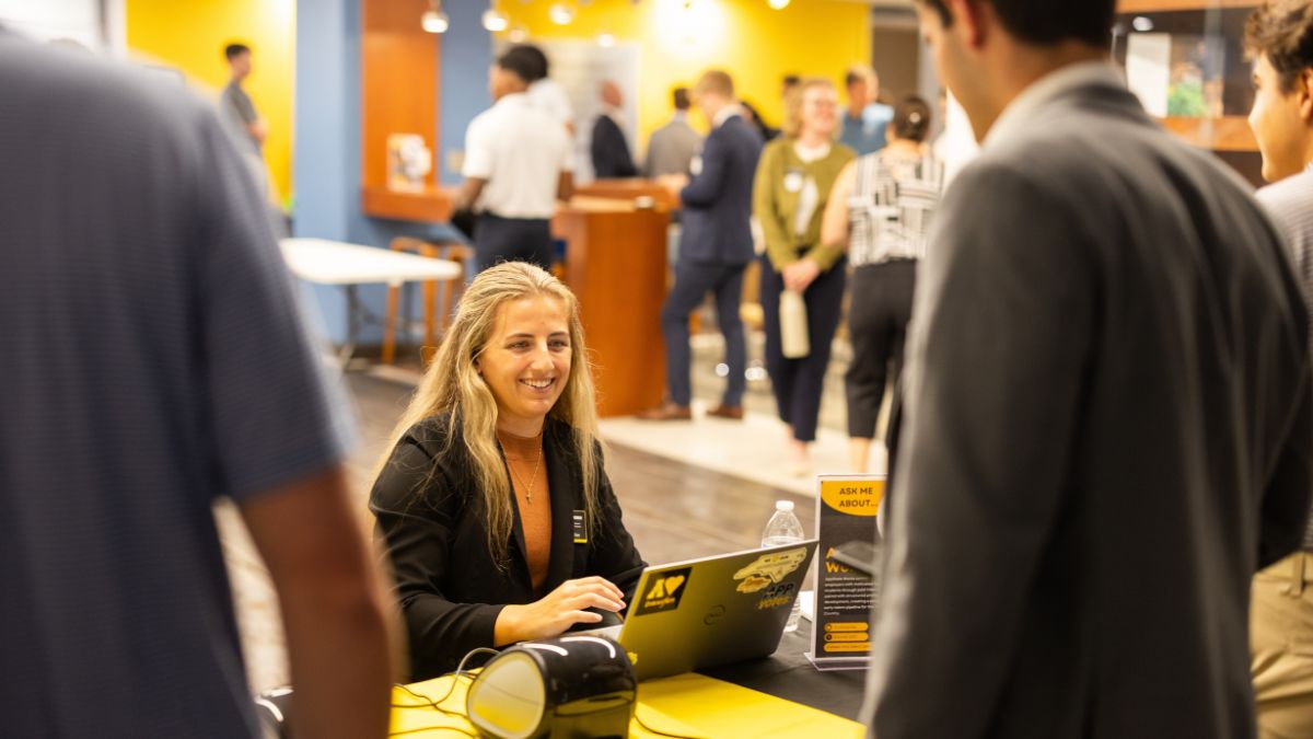 Abby Brannen, a Business Career Services staff member, checks students in as attendees arrive for Bank Day in Peacock Hall. Photo by Chase Reynolds