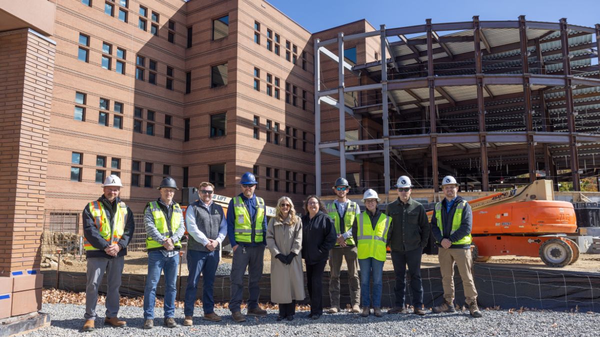 Vannoy Construction and App State leaders stand in front of the Peacock Hall addition project, after the placement of the time capsule beam on October 23, 2025