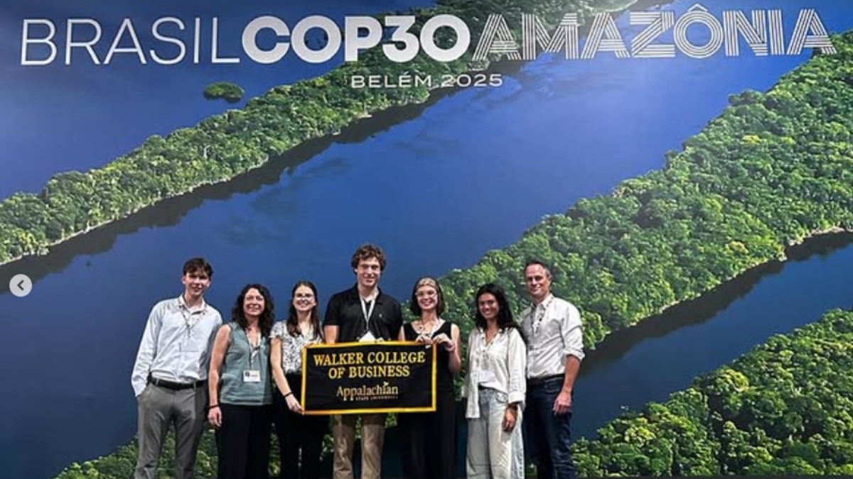 App State delegates to COP30 hold up a Walker College of Business banner