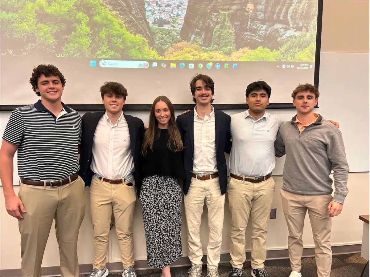 Emily Bills, co-founder of App State's Real Estate Club, is pictured, center, with club members in Peacock Hall.