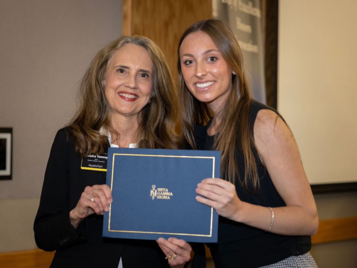 Emily Bills, right, with Dean Sandra Vannoy is honored as top management student and Beta Gamma Sigma member during the 2025 WCOB Honors Convocation.