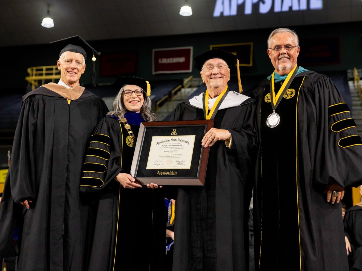 Appalachian Trustee Secretary Jamie Harris, Appalachian Chancellor Heather Norris, G.A. Sywassink, and UNC System Governor Philip Byers in academic regalia on December 12, 1995. Chancellor Norris and Mr. Sywassink hold the framed doctorate degree