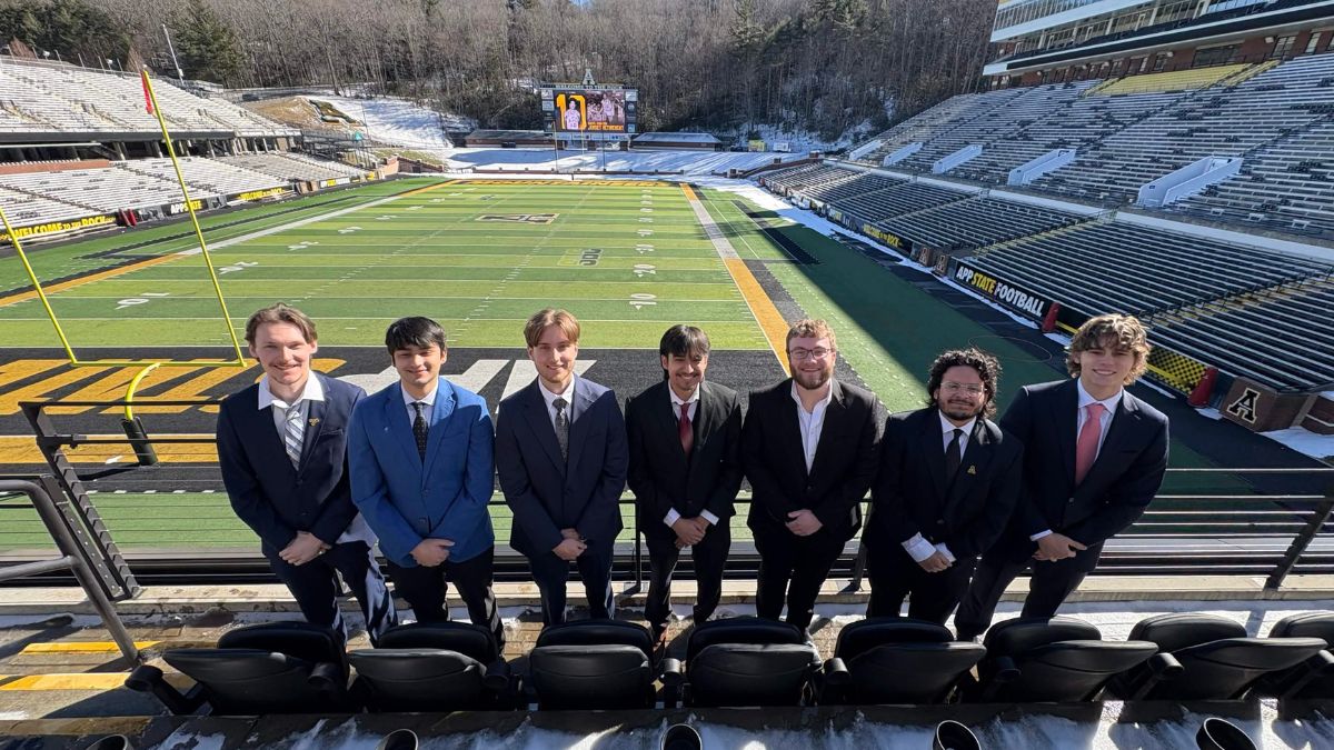 Students at App State's Kidd Brewer Stadium, dressed in suits
