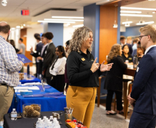A banking professional speaks with students during Bank Day in Peacock Hall, helping connect future business leaders with industry opportunities. Photo by Chase Reynolds