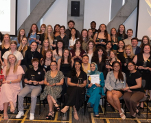 Dozens of recipients of App State Black and Gold Awards smiling at the awards ceremony