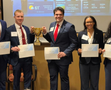 2026 Broyhill Fellows stand with certificates and a trophy after winning the CFA Institute Research Challenge Americas Region first round
