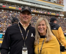 Dennis Covington ’92, left, and his wife, Katherine, have donated $1.3 million in support of facilities for App State Athletics and academic resources for the Walker College of Business. They are pictured in the end zone of Kidd Brewer Stadium during an App State football game. 