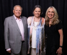 Kathy Pou, center, earned her BSBA degree in economics from App State's Walker College of Business in 1979. In 2025, she was named alumna of the year for the Walker College of Business. She stands with her husband, Bill, and Walker College Dean Sandra Vannoy. 