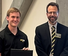 Kyle Vetter, left, receives a certificate for best research poster