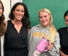 Lauren Solomon '06 MKT with students who earned Stanley Quencher cups for their engagement