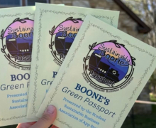 Three passport books with text "Sustainably, Boone Passport - Boone's Green Passport, Presented by the Student Sustainable Business Association of App State"