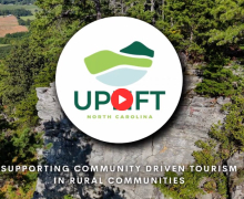 Uplift Video Screenshot An Uplift logo includes mountains, valleys and waterways and is displayed over a North Carolina outdoor scene