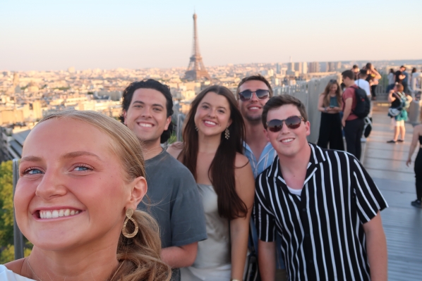 2023 cohort participants (L-R) Lulu Ambrose, Andrew Bressler, Mackenzie Naylor, Connor Marx and Finn Jarrell enjoy the view from the Arc de Triomphe in Paris.