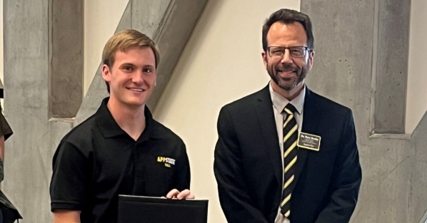Kyle Vetter, left, receives a certificate for best research poster