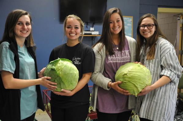 From left, Walker College of Business Fellows Avery Fink, Taelor Critcher, Rachel Foutz and Rachel Wynn volunteer at Green Street Catering's Nov. 17 packing party to assemble Thanksgiving food baskets for families in need.