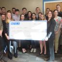 NCSLA Stamping Office Chair Danielle Wade, holding check at left, with Brantley Risk & Insurance Center Director Dave Marlett, far left, Walker College of Business Dean Heather Norris, holding check at right, and student participants of the 2018 London trip