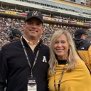 Dennis Covington ’92, left, and his wife, Katherine, have donated $1.3 million in support of facilities for App State Athletics and academic resources for the Walker College of Business. They are pictured in the end zone of Kidd Brewer Stadium during an App State football game. 