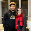Appstate leading rusher and management major Marcus Cox with Walker College of Business Dean Heather Norris
