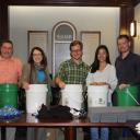 Walker College of Business Dean Norris, second from left, with AppState Executive Impact Club members Tim Walker, Logan Edwards, Teea Wan and Wade Hampton assemble flood buckets for hurricane relief.