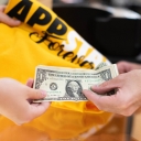 An Appalachian State University Bookstore customer makes a purchase using cash. On average, people spend 17% more with credit or debit cards than they do with cash, according to Bryan Bouboulis, director of App State’s financial literacy initiative — a program providing money management resources and personal consultations for students. 