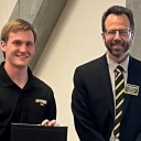 Kyle Vetter, left, receives a certificate for best research poster