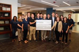 Front row, from left, are BCBS director of sales Ashlee Smart, retail operations manager Alec Hoffman, Boone center manager Wayne Randall, and vice president Gary Bolt presenting a $25,000 check to Appalachian’s Brantley Risk and Insurance center director Dave Marlett and business career services associate director Amy Odom.