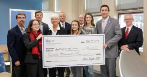 Dean Heather Norris, second from left, receives a $70,000 check from Independent Insurance Agents of North Carolina CEO Aubie Knight, second from right. 