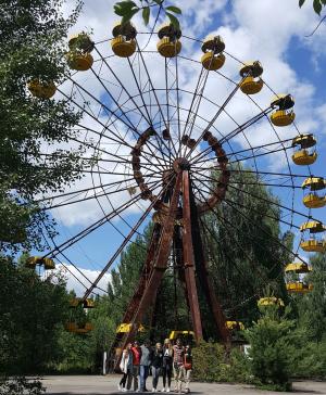 Appalachian State University students Sarah Willis, Trace Edmunds, Nikolas Kapetanich-Pittser, Jordan Silcox, Sloan Evans, Alex Angeli, and Walker College Associate Dean Sandra Vannoy stand in front of the iconic Ferris wheel at the site of the long-abandoned Pripyat amusement park near Chernobyl.