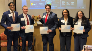 2026 Broyhill Fellows stand with certificates and a trophy after winning the CFA Institute Research Challenge Americas Region first round