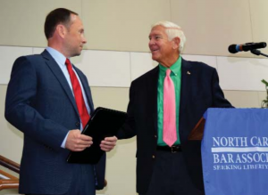 Allan Head, right, congratulates his successor, Jason Hensley.