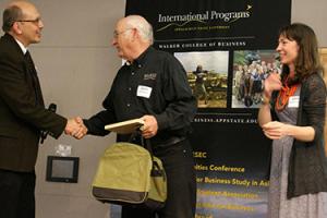 Dr. Al Harris, center, receives the Lifetime Achievement Award from Dr. Marty Meznar, left.