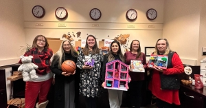 Staff members in the Walker College of Business display some of the toys the Walker Impact Network donated