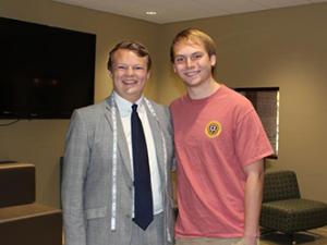 Zach Hunt measured for a business suit by Corner Tailors Founder Merrick Marquie