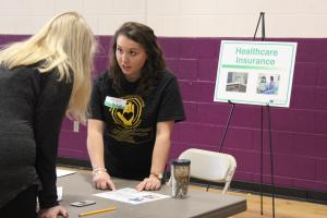 RMI major Abby Young offers financial advice to an Ashe County High School student during a financial literacy workshop offered by the Walker College of Business in partnership with SECU and Appalachian GearUp.