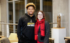 Appstate leading rusher and management major Marcus Cox with Walker College of Business Dean Heather Norris