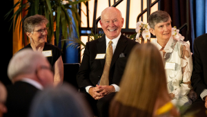 Doug Johnson, center,with two fellow awardees at the 2026 Alumni Gala. Photo by Kyla Willoughby