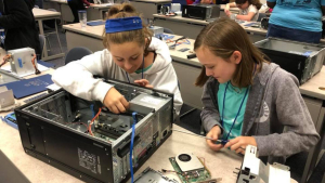 Middle school students work on a hands‑on IT project during a previous summer camp.