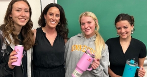 Lauren Solomon '06 MKT with students who earned Stanley Quencher cups for their engagement