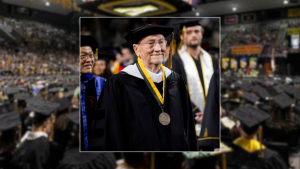 G.A. Sywassink wearing academic regalia and medallion