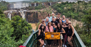 A group of students at Iguacu Falls on the Brazil and Argentina border in May. These falls lie a few miles from the largest hydroelectric plant in the Western Hemisphere, a place the students visited during the program. 