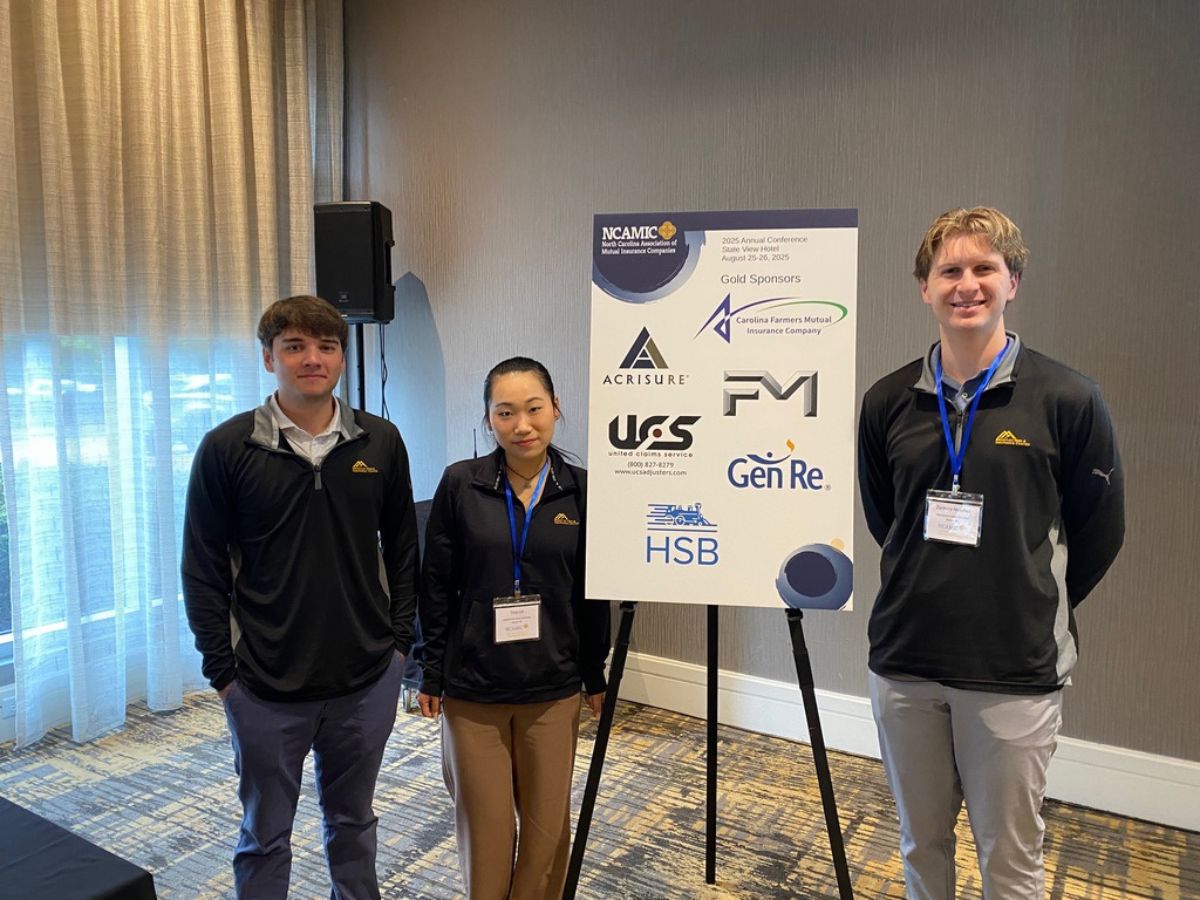 Three students at a GIS event